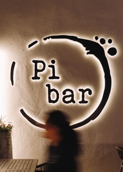 Pi Bar’s glowing exterior sign at night, captured by Luma Creative, a San Francisco social media marketing agency